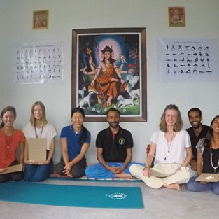 students are all smiles after receiving their completion certificates for the 5-Month Yoga TTC