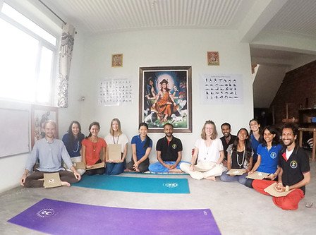11 students being felicitated with their yoga teacher training certificates after successful completion of the course