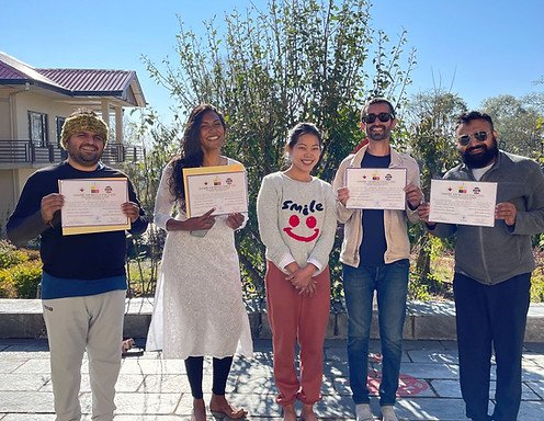 smiling faces of students after they received their certificates post the completion of their yoga ttc training in india