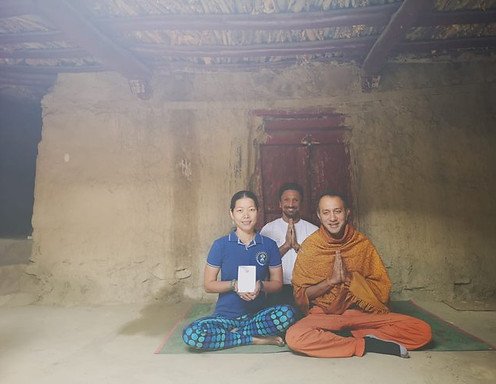 Thanida and Roshanji smiling after handing out certificate to Ashray Sood, once he completed his training of the yoga TTC in Spiti Tabo